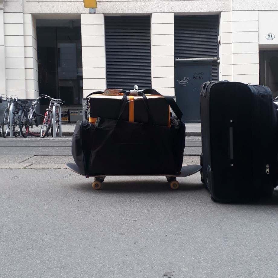 A desktop computer in a bag on a skateboard